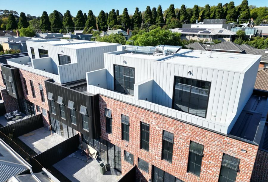 hartington st apartments kew facade with bricks and white cladding - total roof and cladding