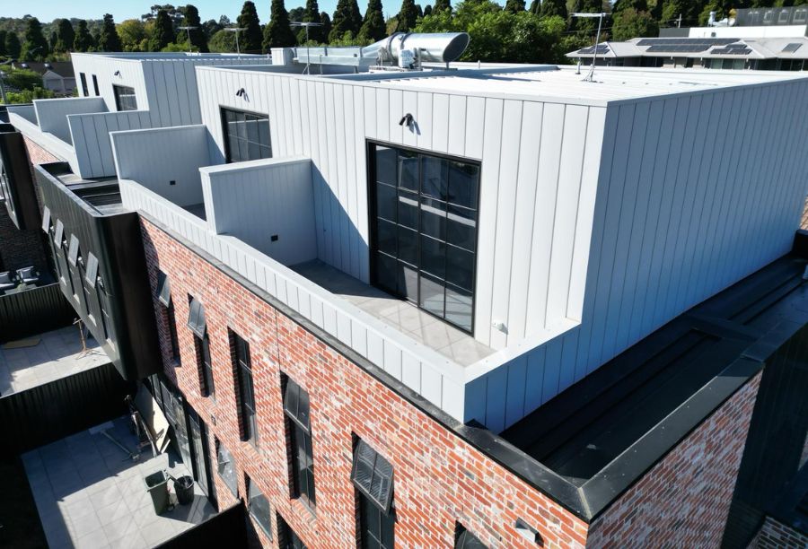 hartington st apartments kew with bricks and white cladding - total roof and cladding